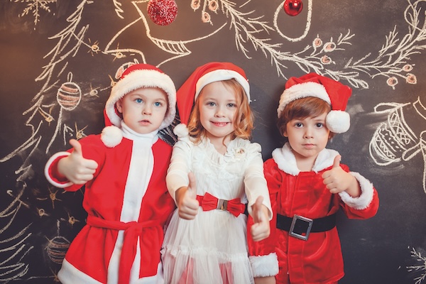 Children,Dressed,As,Santa,Claus,Standing,And,Show,Thumb,On